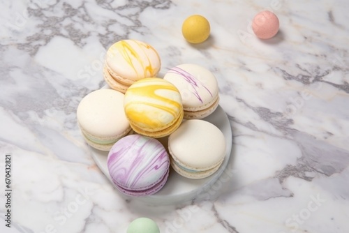 french macarons in pastel colors on marble surface