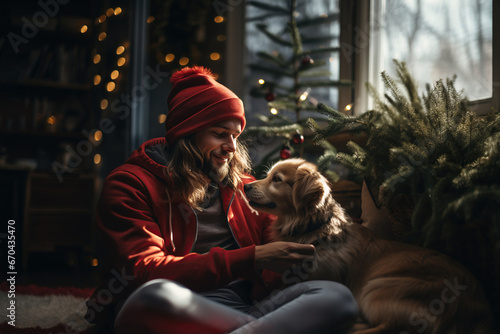 Cozy holiday scene with a man and his dog in front of Christmas tree