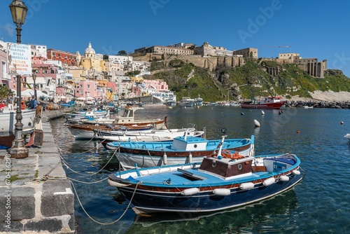 Idyllic marina scene of Procida Marina Grande port in Campania, Italy with fishing boats