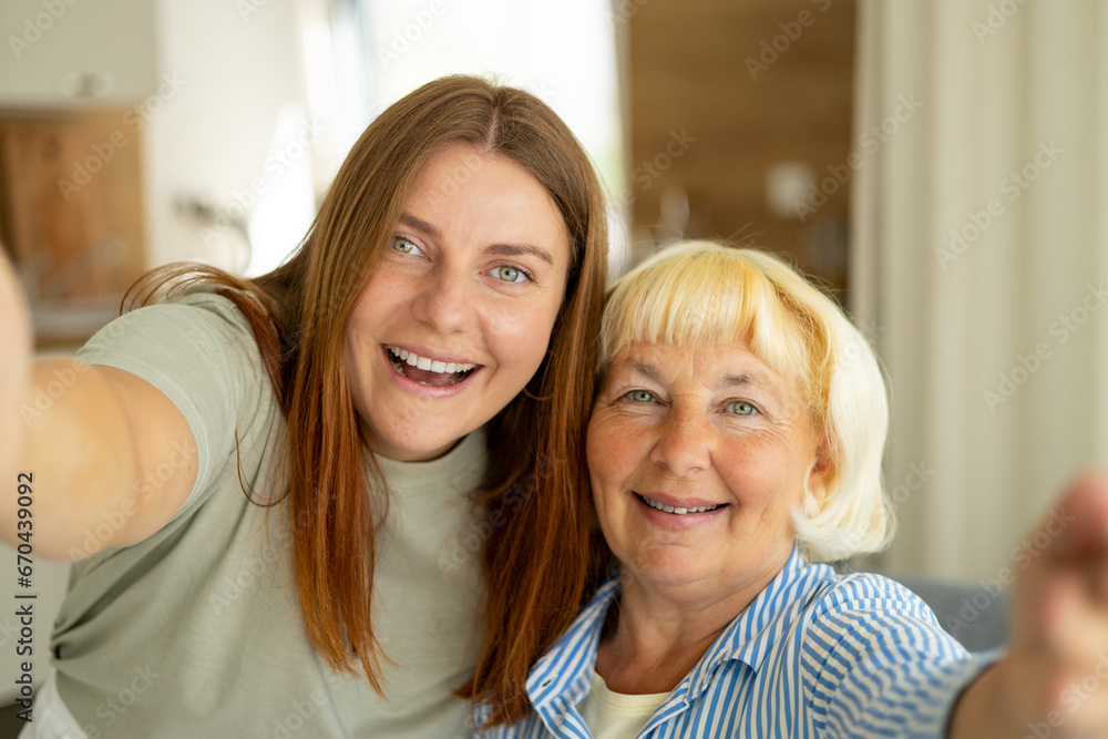 Head shot portrait happy woman with mature mother taking selfie together, Happy senior woman enjoying in daughter's affection on Mother's day. Head shot portrait happy woman with mature mother taking selfie together, Happy senior woman enjoying in daughter's affection on Mother's day.