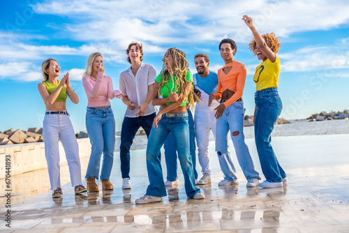 Multi-ethnic friends in a dance battle in an urban square