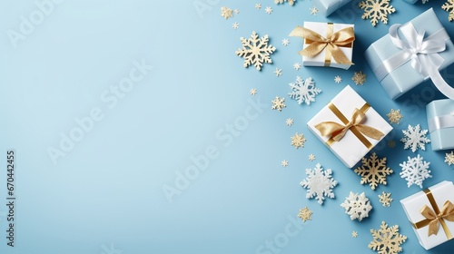 Christmas flat lay background with christmas present box and red decorations on blue with light bokeh effect. Top view with copy space.