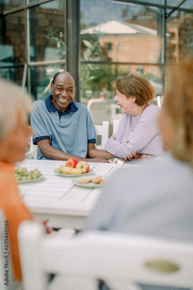 Senior man and woman sitting at dining table Senior man and woman sitting at dining table