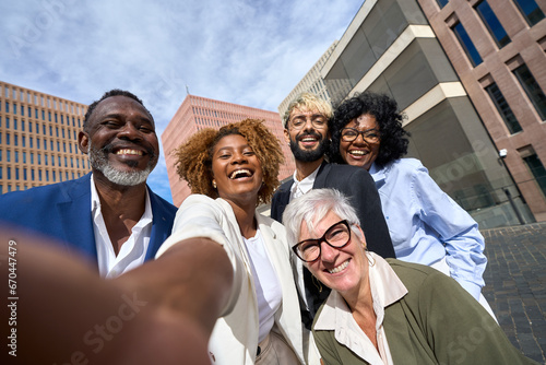 Happy multi-ethnic colleagues taking a selfie outdoors © alvaro