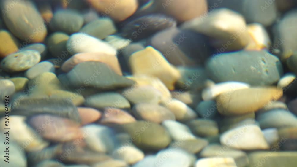 Sea beach pebble. Sea waves with soft, foamy waters washing multicolored pebbles on a beach during sunset. Nobody. Holiday recreation concept. Abstract nautical summer ocean sunset nature Slow motion Sea beach pebble. Sea waves with soft, foamy waters washing multicolored pebbles on a beach during sunset. Nobody. Holiday recreation concept. Abstract nautical summer ocean sunset nature Slow motion