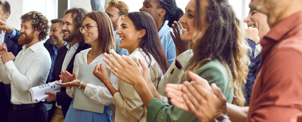 Applauding people. Happy satisfied audience joyfully applauding during business conference or seminar. Side view portrait of smiling men and women clapping their hands. Panoramic web banner.