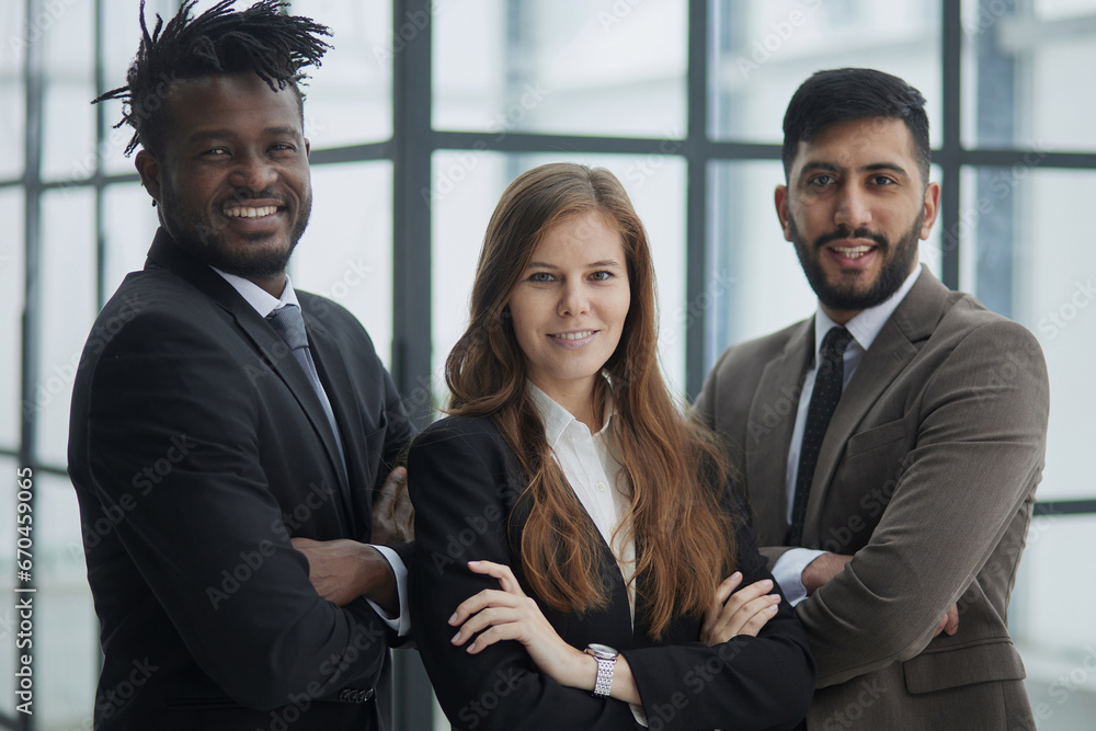 a group of three employees posing together with their arms crossed a group of three employees posing together with their arms crossed