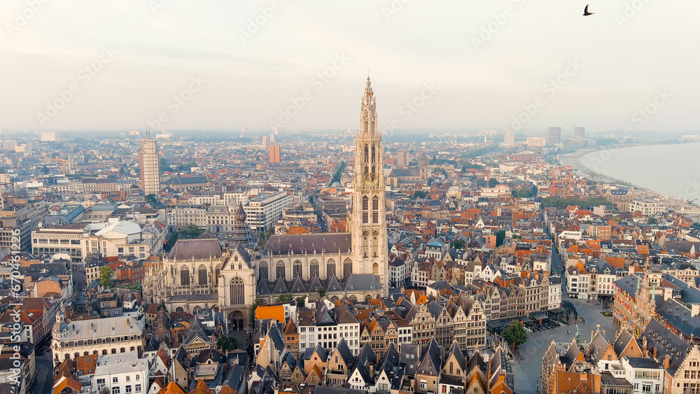 Antwerp, Belgium. Spire with the clock of the Cathedral of Our Lady (Antwerp). Historical center of Antwerp. City is located on river Scheldt (Escaut). Summer morning, Aerial View - obrazy, fototapety, plakaty 