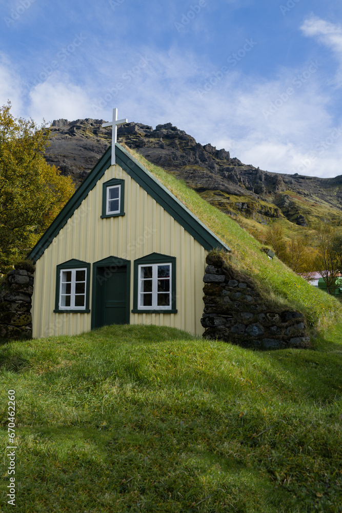 .Hofskirkja church in Iceland with green grass on top