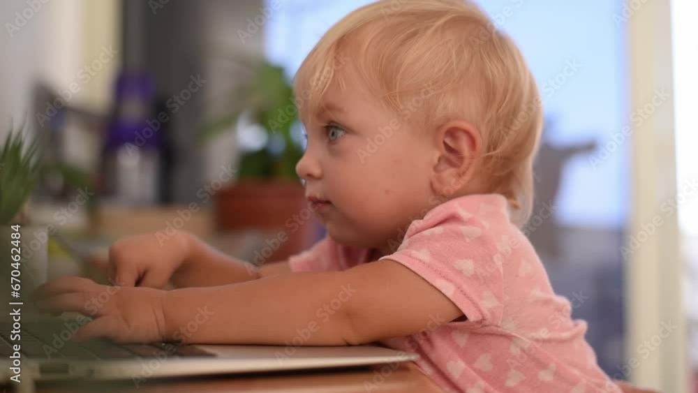Little happy baby smile and typing on keyboard of laptop. Small hand fingers touch black buttons. Baby learning new world. play on laptop. Little happy baby smile and typing on keyboard of laptop. Small hand fingers touch black buttons. Baby learning new world. play on laptop.
