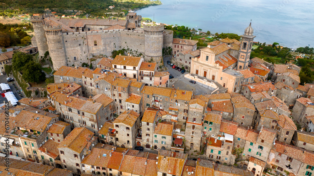 Aerial view of the castle and cathedral of Santo Stefano in the historic center of Bracciano, in the metropolitan city of Rome, Italy. The town is located on the shores of Lake Bracciano.