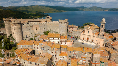 Aerial view of the castle and cathedral of Santo Stefano in the historic center of Bracciano, in the metropolitan city of Rome, Italy. The town is located on the shores of Lake Bracciano. © Stefano Tammaro