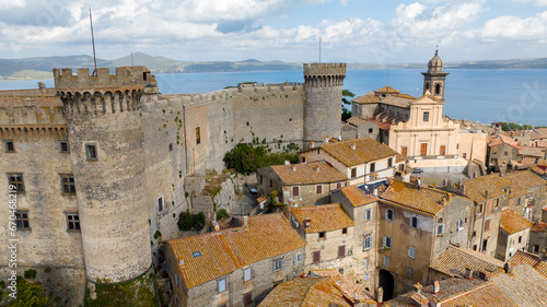 Aerial view of the castle and cathedral of Santo Stefano in the historic center of Bracciano, in the metropolitan city of Rome, Italy. The town is located on the shores of Lake Bracciano.