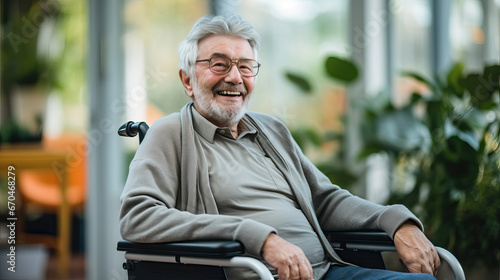 Portrait of a happy senior man sitting on wheelchair. Cheerful old man sitting on wheelchair. Disabled man in his wheelchair looking at camera.