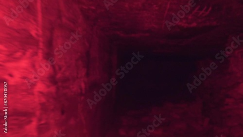 Limestone quarry (stone sawing), which is 200 years old. Underground halls, piles of sawn stones, zigzag corridors, dead ends. Object for spelunking. Red light illumination deepens the mystery photo