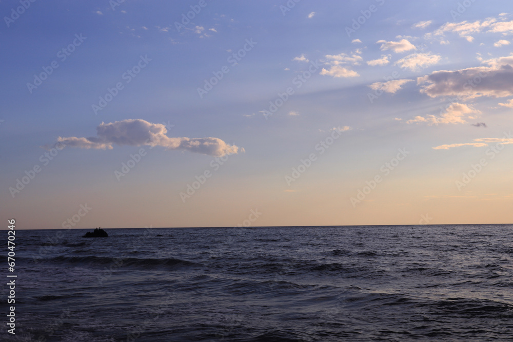 Evening sky at sunset by the sea. Sea background.