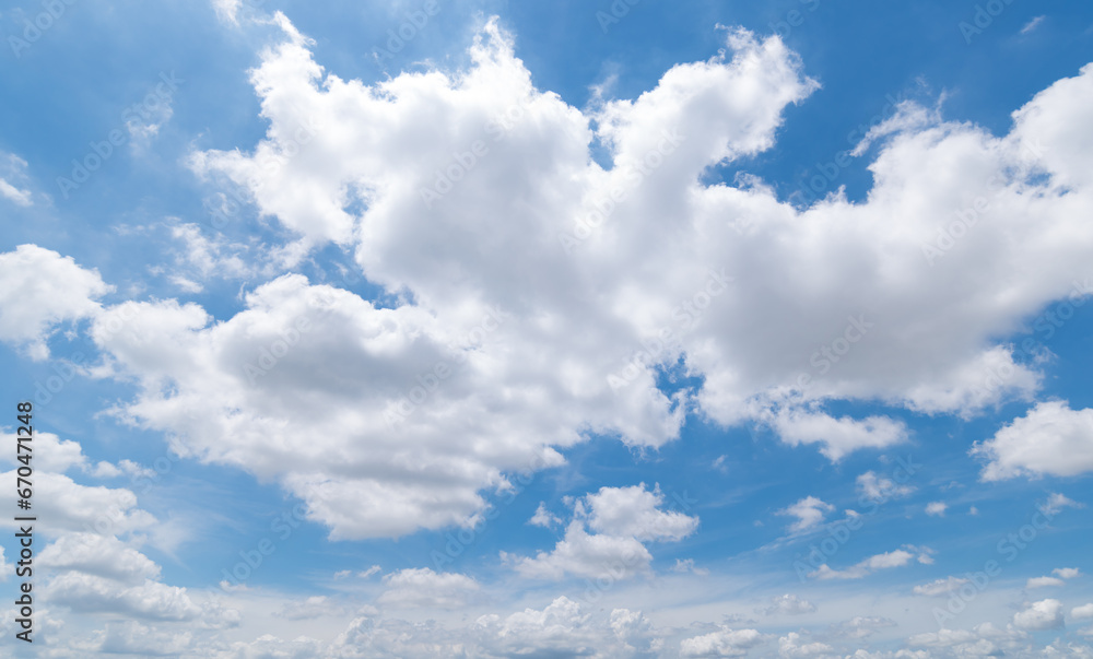 Fototapeta premium Panoramic view of clear blue sky and clouds, Blue sky background with tiny clouds. White fluffy clouds in the blue sky. Captivating stock photo featuring the mesmerizing beauty of the sky and clouds.