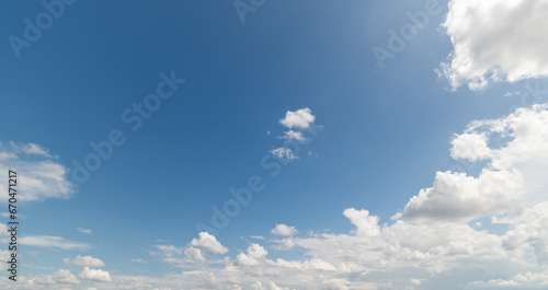 Panoramic view of clear blue sky and clouds  Blue sky background with tiny clouds. White fluffy clouds in the blue sky. Captivating stock photo featuring the mesmerizing beauty of the sky and clouds.