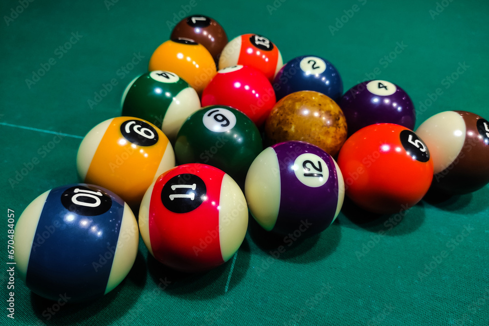 Pool cues close-up on a green table for playing Pool cues close-up on a green table for playing