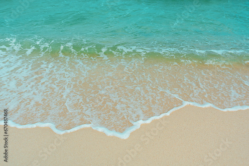 Soft wave of blue ocean on sandy beach. Summer vacation in island. clear azure water Background.