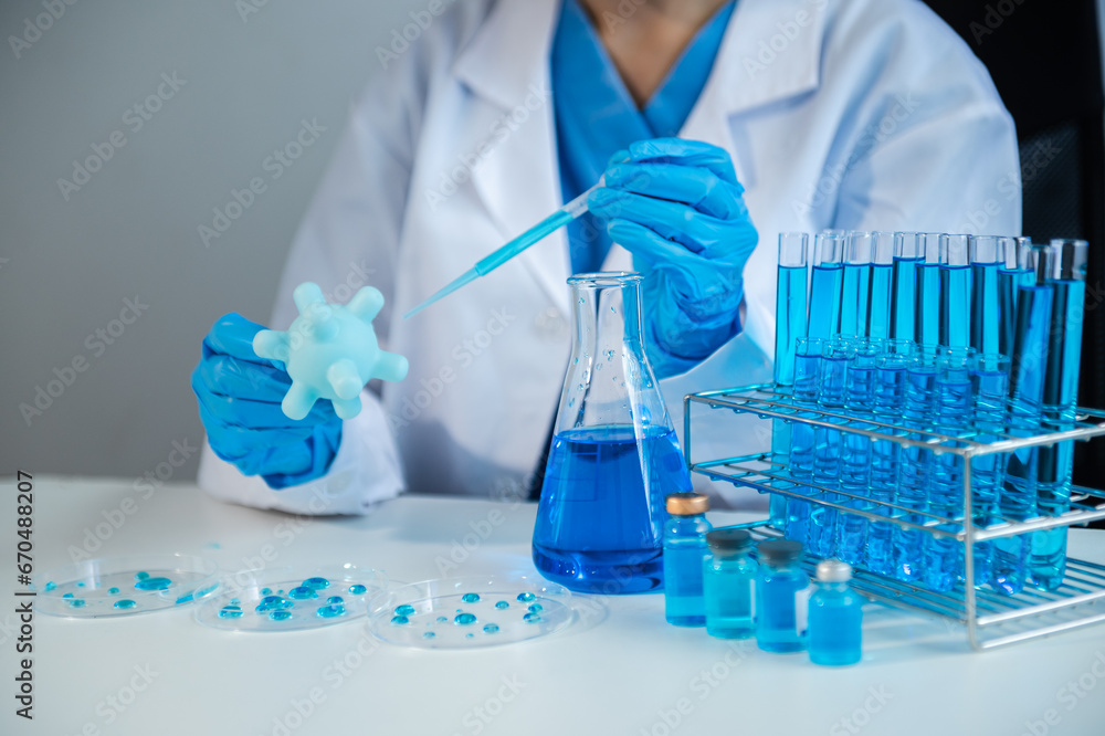 Fototapeta premium Scientist mixing chemical liquids in the chemistry lab. Researcher working in the chemical laboratory.