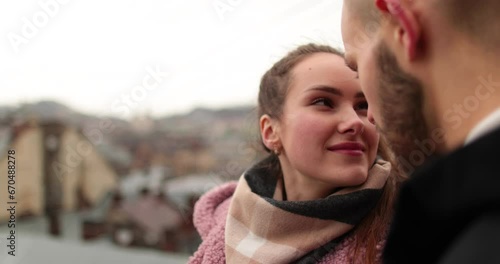 Two lovers kiss on an autumn day in a city street. Intimate intimacy of a couple close-up. Modern love and relationship of a young couple. photo