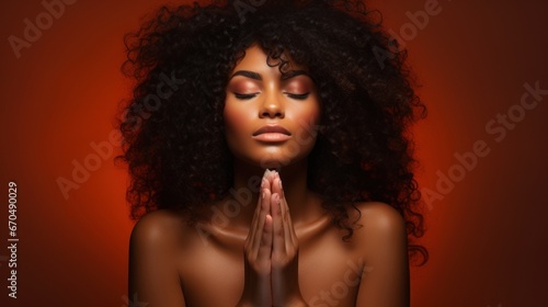 Beautiful african american woman praying with closed eyes on orange background Generative AI