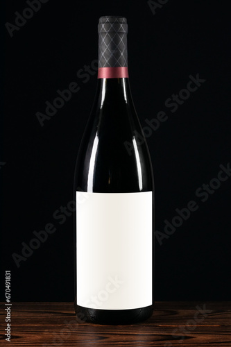 Red wine bottle with blank label on a wooden background