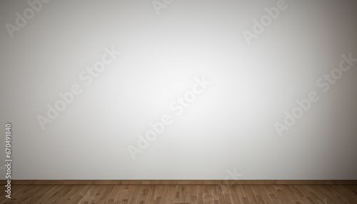 Empty gray wall in room with wooden floor.