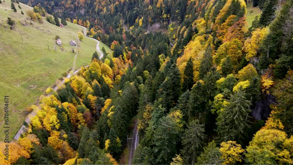 Panoramic aerial view of Swiss funicular railways traversing a dense autumn forest in a beautiful alpine scenery showcasing the Rigi Mountain in the Alps of Switzerland
Panoramic aerial view of Swiss funicular railways traversing a dense autumn forest in a beautiful alpine scenery showcasing the Rigi Mountain in the Alps of Switzerland