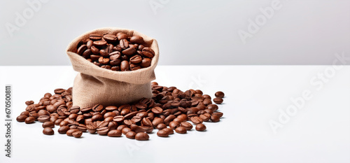 Bag of fresh roasted coffee beans isolated on white background. Banner © Denis