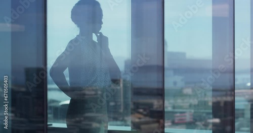 Business, woman and window with thinking of planning, idea or strategy for proposal or corporate decision. Professional, employee and reflection at workplace or office with thoughtful for analysis photo