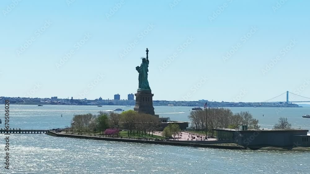 Aerial zoom shot showing famous Statue of Liberty during sunny day in New York City