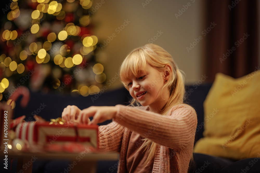 Happy little girl preparing gifts for Christmas day Happy little girl preparing gifts for Christmas day