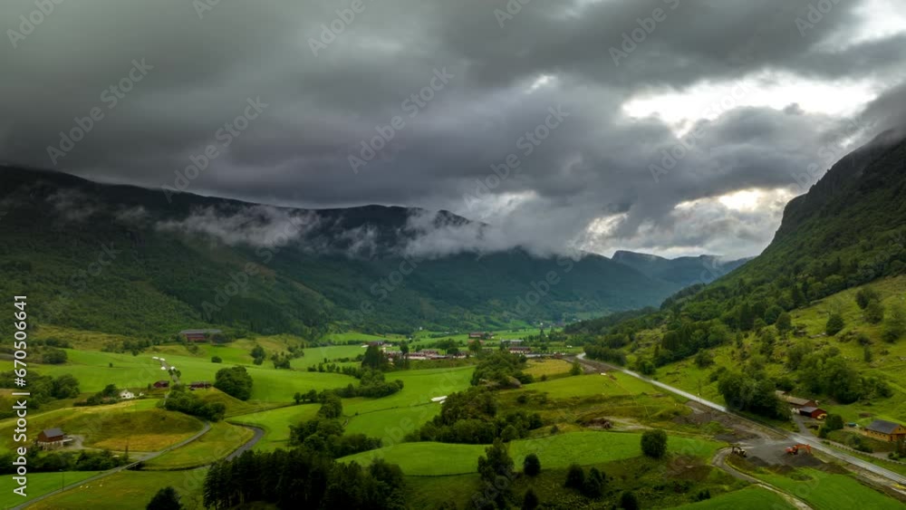 Rural Norway, farming settlement in valley. Aerial hyperlapse of dramatic clouds and mountains. Rural Norway, farming settlement in valley. Aerial hyperlapse of dramatic clouds and mountains.