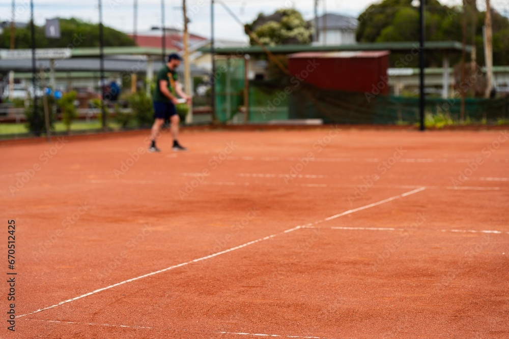 tennis player playing on a clay tennis court in australia