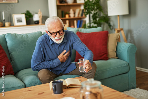 A senior man suffering from chest pain or heart attack at home © Stockphotodirectors