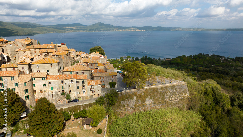 Aerial view of the historic center of Bracciano, in the metropolitan city of Rome, Italy. The town is located on the shores of Lake Bracciano.
