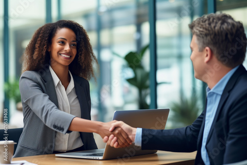 Woman accepting business deal, handshake with client and colleague