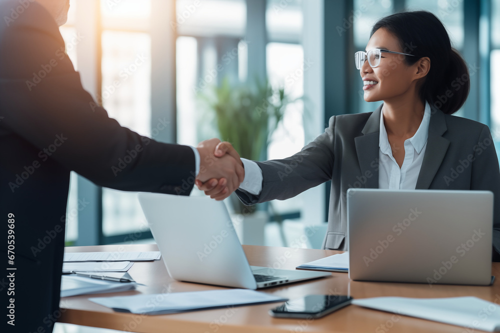 Woman accepting business deal, handshake with client and colleague Woman accepting business deal, handshake with client and colleague