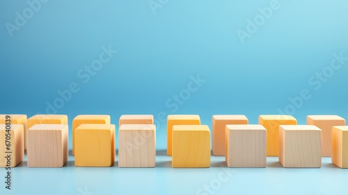 Diversity, individuality or difference concept. Selective focus wooden cubes with yellow color at the center isolated on blue background. photo