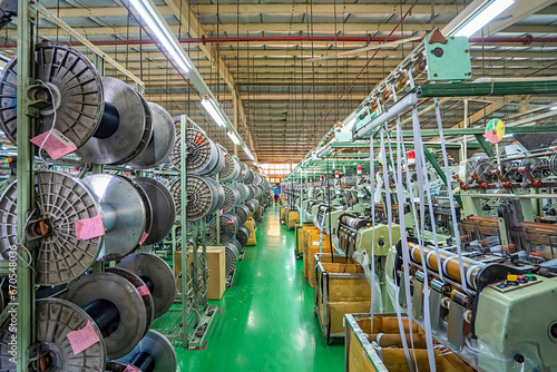 Elastic weaving workshop at textile factory in industrial zone in Ho Chi Minh City, Vietnam, with modern machinery and technology systems. photo