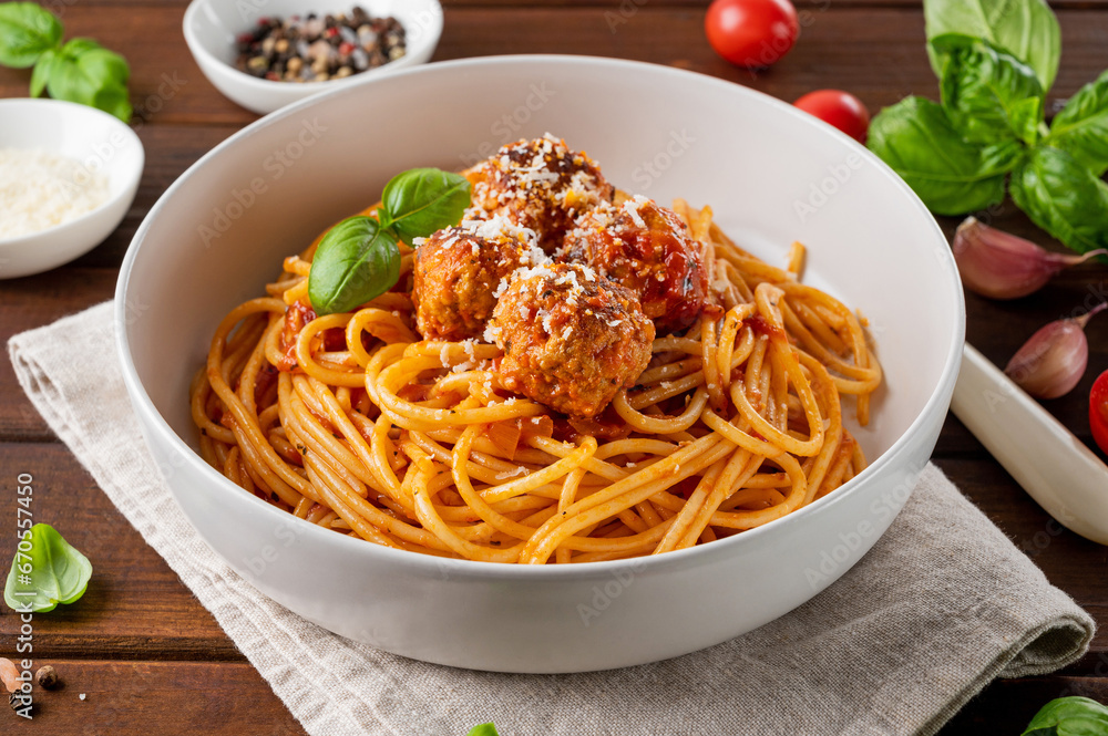 Traditional Italian spaghetti pasta with meatballs, tomato sauce and parmesan cheese, selective focus. Comfort food.