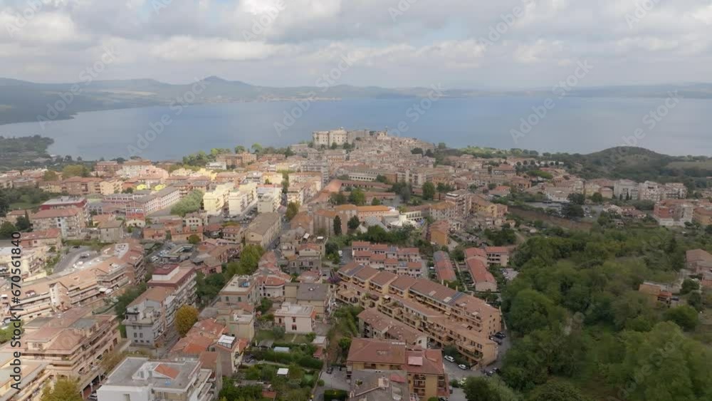 Aerial view of Bracciano, in the metropolitan city of Rome, Italy. The town is located on the shores of Lake Bracciano. In the historic center there is the castle and cathedral of Santo Stefano. Aerial view of Bracciano, in the metropolitan city of Rome, Italy. The town is located on the shores of Lake Bracciano. In the historic center there is the castle and cathedral of Santo Stefano.