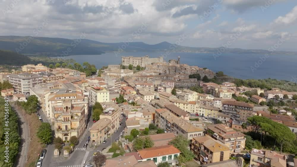 Aerial view of Bracciano, in the metropolitan city of Rome, Italy. The town is located on the shores of Lake Bracciano. In the historic center there is the castle and cathedral of Santo Stefano. Aerial view of Bracciano, in the metropolitan city of Rome, Italy. The town is located on the shores of Lake Bracciano. In the historic center there is the castle and cathedral of Santo Stefano.