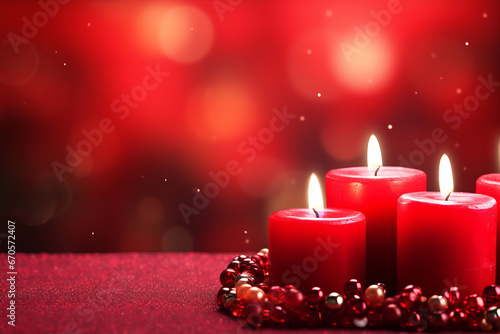 Kwanza backdrop with a group of red  lit candles surrounded by metallic red and silver beads on a table covered in red fabric against a blurred dark red background with lights