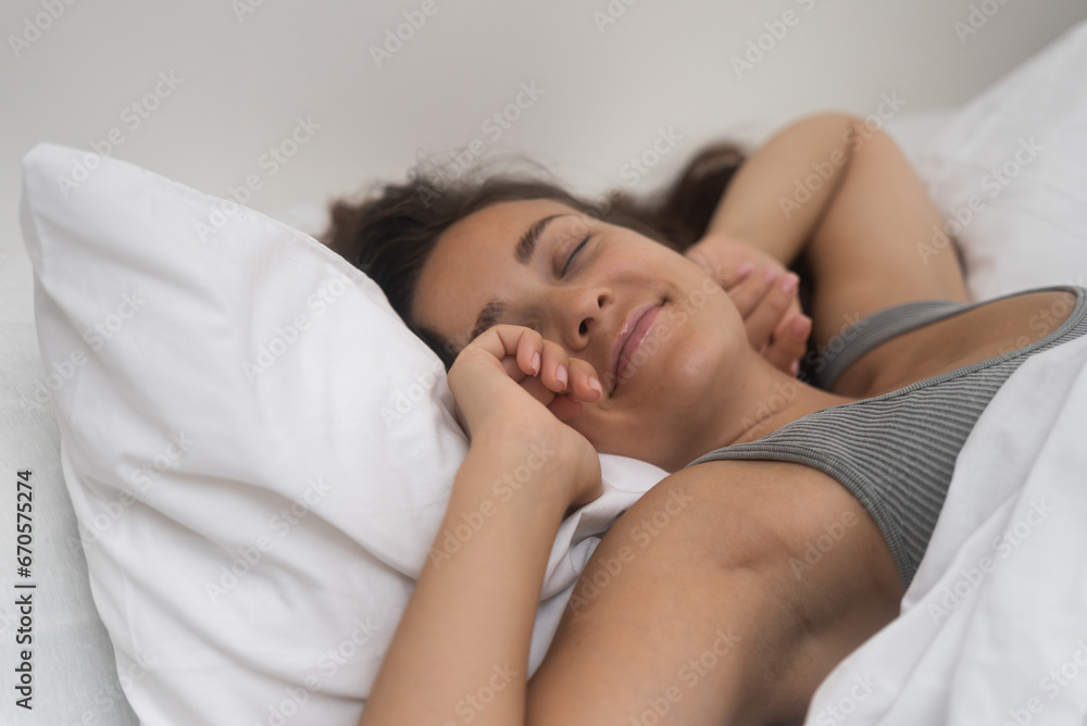 woman wakes up, stretching after peaceful sleep, embracing the start of a new day. woman wakes up, stretching after peaceful sleep, embracing the start of a new day.