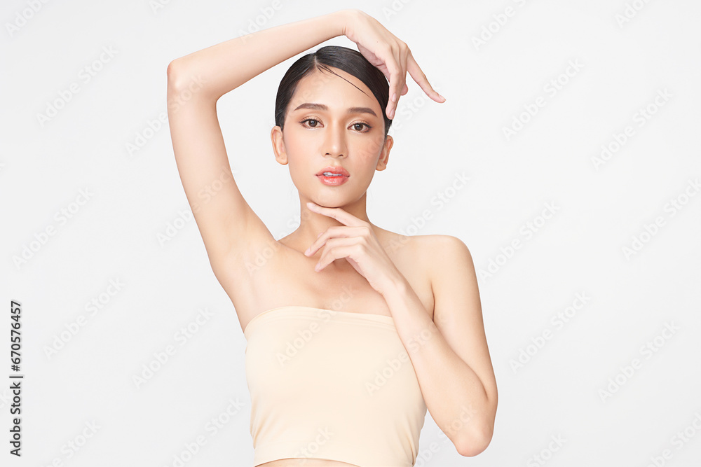 Beautiful Young Asian woman lifting hands up to show off clean and hygienic armpits or underarms on white background, Smooth armpit cleanliness and protection concept Beautiful Young Asian woman lifting hands up to show off clean and hygienic armpits or underarms on white background, Smooth armpit cleanliness and protection concept