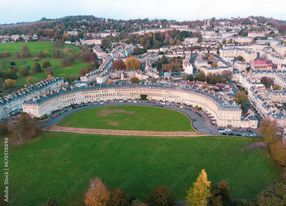 The Royal Crescent in Bath city skyline with a sunset sky in autumn. Leaves brown color in England UK. Arial photography with drones.