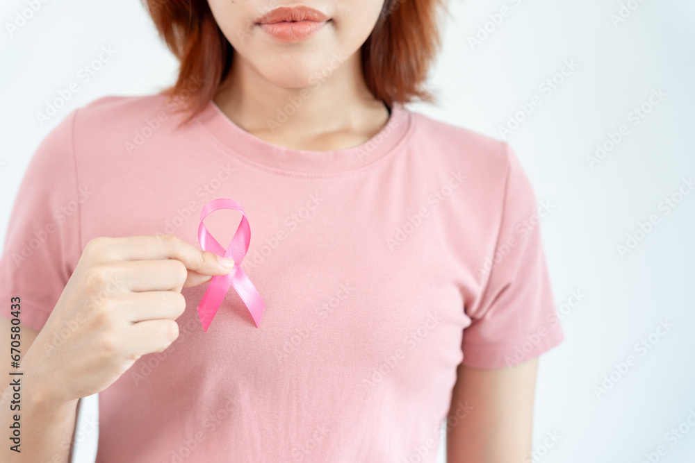 Woman hold pink ribbon breast cancer awareness. Female health check consciousness. international Women Day and World Cancer Day. sign cancer, Symbolic, health care, support patients, timely diagnosis Woman hold pink ribbon breast cancer awareness. Female health check consciousness. international Women Day and World Cancer Day. sign cancer, Symbolic, health care, support patients, timely diagnosis